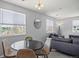 Cozy living room features a modern sofa, stylish lighting, and large windows offering natural light and neighborhood views at 3228 W Girard Ave # C, Englewood, CO 80110