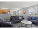 Bright living room featuring neutral walls, plush gray sofas, and ample natural light from multiple windows at 3228 W Girard Ave # C, Englewood, CO 80110