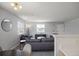 Bright living room featuring neutral walls, plush gray sofas, and ample natural light from multiple windows at 3228 W Girard Ave # C, Englewood, CO 80110