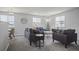 Bright living room featuring neutral walls, plush gray sofas, and ample natural light from multiple windows at 3228 W Girard Ave # C, Englewood, CO 80110