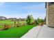 A lush backyard features artificial turf, landscaping, and a wood fence surrounding the property at 8179 S Kellerman Cir, Aurora, CO 80016