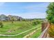 A grassy backyard offers a scenic view of neighboring houses and a walking trail at 8179 S Kellerman Cir, Aurora, CO 80016