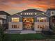 The backyard features lush green grass and a spiral staircase that leads from the top patio to the yard at 8179 S Kellerman Cir, Aurora, CO 80016