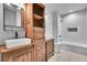 Elegant bathroom with modern vanity, dual sinks, and walk-in tiled shower and tub at 8179 S Kellerman Cir, Aurora, CO 80016
