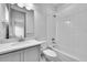 Bathroom with a shower/tub combo, single sink, and gray cabinets at 8179 S Kellerman Cir, Aurora, CO 80016