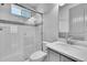 Clean bathroom with a glass-enclosed shower, sleek vanity, and coordinated finishes at 8179 S Kellerman Cir, Aurora, CO 80016