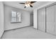 Cozy bedroom with neutral walls, carpet, and a ceiling fan with an attached closet at 8179 S Kellerman Cir, Aurora, CO 80016