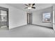 Large bedroom featuring neutral walls, plush carpeting, ample natural light, and a ceiling fan at 8179 S Kellerman Cir, Aurora, CO 80016