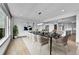 Elegant dining room with modern lighting, large windows, and seamless access to the kitchen at 8179 S Kellerman Cir, Aurora, CO 80016