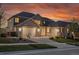 Elegant home with a three-car garage, well-manicured landscaping, and a warm, inviting facade at 8179 S Kellerman Cir, Aurora, CO 80016