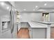 Basement kitchenette with stainless steel refrigerator and modern countertops at 8179 S Kellerman Cir, Aurora, CO 80016