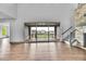 Bright living room with hardwood floors, stone fireplace and large sliding glass doors to the outside deck at 8179 S Kellerman Cir, Aurora, CO 80016