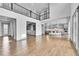 Bright, open-concept living area with hardwood floors and modern finishes at 8179 S Kellerman Cir, Aurora, CO 80016