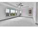 Spacious main bedroom featuring a tray ceiling, large windows, and plush carpeting at 8179 S Kellerman Cir, Aurora, CO 80016