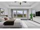 Cozy main bedroom with a large window offering picturesque views and a ceiling fan at 8179 S Kellerman Cir, Aurora, CO 80016