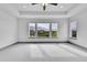 Spacious main bedroom featuring tray ceilings, ceiling fan, and large windows with neighborhood views at 8179 S Kellerman Cir, Aurora, CO 80016
