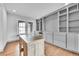 Home office featuring custom built-ins, hardwood floors, and natural light at 8179 S Kellerman Cir, Aurora, CO 80016