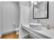 Stylish powder room featuring a modern vessel sink, elegant faucet, and contemporary design at 8179 S Kellerman Cir, Aurora, CO 80016