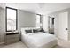 Cozy bedroom with a large bed, stylish wallpaper, and ample natural light from big windows at 580 S Franklin St, Denver, CO 80209