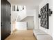 Bright entryway with modern bench, light wood floors, and black door at 580 S Franklin St, Denver, CO 80209