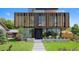 Modern home with wood and metal siding, expansive windows, and landscaped lawn at 580 S Franklin St, Denver, CO 80209