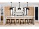 Modern kitchen featuring a large marble island with seating, custom cabinetry, and designer pendant lighting at 580 S Franklin St, Denver, CO 80209