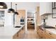 Gourmet kitchen showcasing a large island, premium appliances, custom cabinetry, and open shelving at 580 S Franklin St, Denver, CO 80209