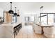 Bright, open-concept living space with a marble island and dining area with comfortable chairs and modern lighting at 580 S Franklin St, Denver, CO 80209