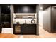 Finished basement bar area with black cabinets, a wine fridge, and stylish shelving at 580 S Franklin St, Denver, CO 80209