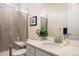 Clean bathroom featuring a glass shower, modern vanity with sink, and elegant fixtures and tile at 8751 S Wenatchee Ct, Aurora, CO 80016