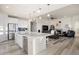 Open concept living room and kitchen with large island, stainless appliances and hardwood floors at 8751 S Wenatchee Ct, Aurora, CO 80016