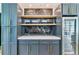 Stylish bar area featuring modern cabinetry, open shelving, and a built-in beverage refrigerator at 2280 W 42Nd Ave, Denver, CO 80211