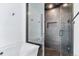 Modern bathroom featuring a soaking tub and a walk-in shower with black hardware at 2280 W 42Nd Ave, Denver, CO 80211