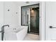 Modern bathroom featuring a soaking tub and a walk-in shower with black hardware at 2280 W 42Nd Ave, Denver, CO 80211
