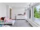 Sun-filled bedroom with big windows, a white dresser, and plush carpet at 2280 W 42Nd Ave, Denver, CO 80211