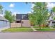 Modern two-story home with brick facade, black metal roof, and a well-manicured front lawn at 2280 W 42Nd Ave, Denver, CO 80211