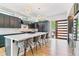 Open kitchen with a center island, dark cabinetry, marble countertops, stainless steel appliances, and pendant lighting at 2280 W 42Nd Ave, Denver, CO 80211