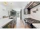 Bright kitchen features a large island, dark cabinets, modern appliances, and an open floor plan at 2280 W 42Nd Ave, Denver, CO 80211