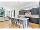 Bright kitchen with white marble countertops, dark cabinets, pendant lights, and stainless steel appliances at 2280 W 42Nd Ave, Denver, CO 80211