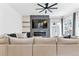 Cozy living room with a gray sectional, fireplace, and a modern ceiling fan at 2280 W 42Nd Ave, Denver, CO 80211