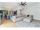 Open concept living room with a large sectional couch, modern ceiling fan, and an island separating kitchen at 2280 W 42Nd Ave, Denver, CO 80211