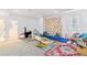 Basement playroom with a climbing wall, toys, and colorful rugs at 2280 W 42Nd Ave, Denver, CO 80211
