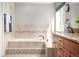 Elegant bathroom with a large soaking tub, vanity with storage, and natural light at 8762 Mourning Dove Ln, Highlands Ranch, CO 80126