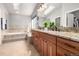 Bright bathroom with double vanity, granite countertops, and a soaking tub, perfect for relaxation at 8762 Mourning Dove Ln, Highlands Ranch, CO 80126