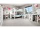 Bright bedroom featuring bunk beds, stylish decor, and a vanity with excellent natural light at 8762 Mourning Dove Ln, Highlands Ranch, CO 80126