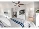 Light-filled bedroom boasts an ensuite bath, wall-mounted TV, and a spacious walk-in closet at 8762 Mourning Dove Ln, Highlands Ranch, CO 80126