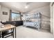 Charming bedroom with a bunk bed, storage cabinets, and cozy study area at 8762 Mourning Dove Ln, Highlands Ranch, CO 80126