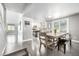 Open-concept dining area with a rustic wooden table set and sliding door access to the outdoors at 8762 Mourning Dove Ln, Highlands Ranch, CO 80126
