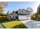 Charming two-story home with brick and gray siding and a well-maintained lawn at 8762 Mourning Dove Ln, Highlands Ranch, CO 80126