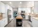 Bright kitchen featuring stainless steel appliances, white cabinets, granite countertops, and a center island at 8762 Mourning Dove Ln, Highlands Ranch, CO 80126